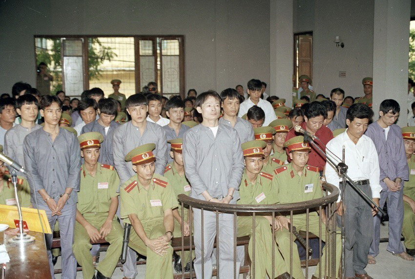 Tháng 5/1996, Cục Cảnh sát hình sự (Bộ Công an) lập chuyên án mang bí số K596, quét sạch băng nhóm tội phạm có tổ chức do Dương Văn Khánh (tức Khánh trắng) cầm đầu về các tội cưỡng đoạt tài sản, thu tiền ''bảo kê'' tại chợ Long Biên (quận Ba Đình, Hà Nội). Trong ảnh: Bị cáo Dương Văn Khánh và 23 bị cáo đứng trước vành móng ngựa tại phiên tòa xét xử (5/9/1997). (Ảnh: Minh Điền/TTXVN)