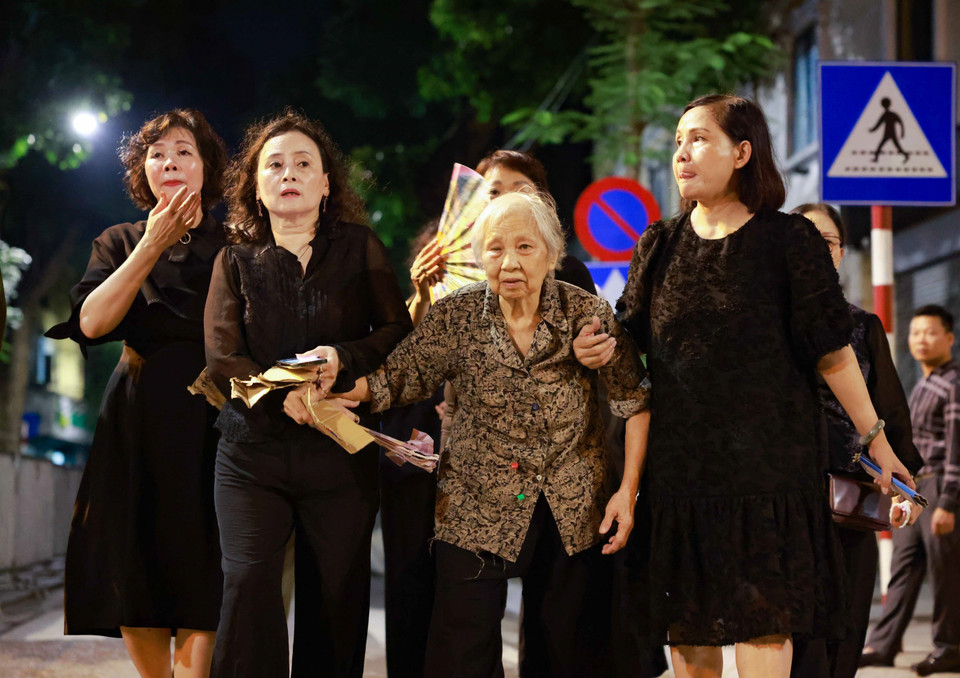 21h45 phút, một người cao tuổi được con cháu đưa tới Nhà tang lễ viếng Tổng Bí thư Nguyễn Phú Trọng. (Ảnh: Thanh Tùng/TTXVN)