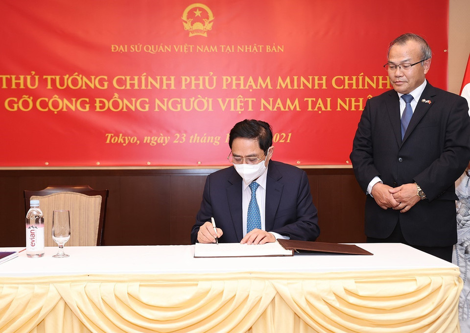 Thủ tướng Phạm Minh Chính viết sổ lưu bút danh dự tại Đại sứ quán Việt Nam tại Nhật Bản. (Ảnh: Dương Giang/TTXVN)