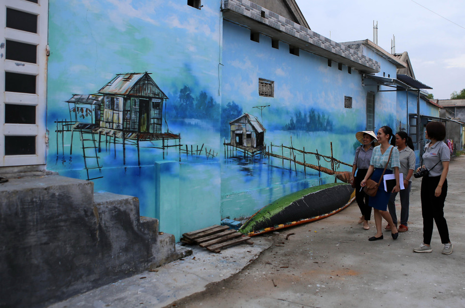 Sự xuất hiện của những bức bích hoạ không chỉ tôn thêm vẻ đẹp cho làng chài mà còn tạo ra điểm nhấn thu hút du khách đến với địa phương này ngày một đông hơn. (Ảnh: Hồ Cầu/TTXVN)