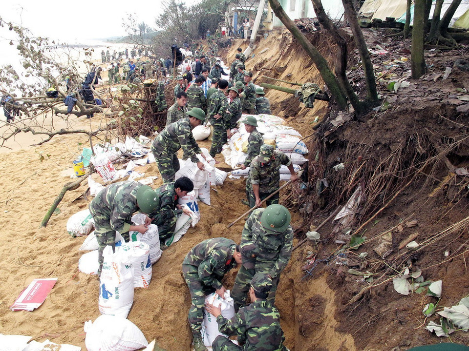  Quân đội nhân dân tham gia phòng, chống thiên tai, cứu hộ, cứu nạn, khắc phục hậu quả chiến tranh… Trong ảnh: Lực lượng bộ đội cùng nhân dân tham gia đắp kè chắn sóng biển xâm thực. (Ảnh: Thanh Long/TTXVN)