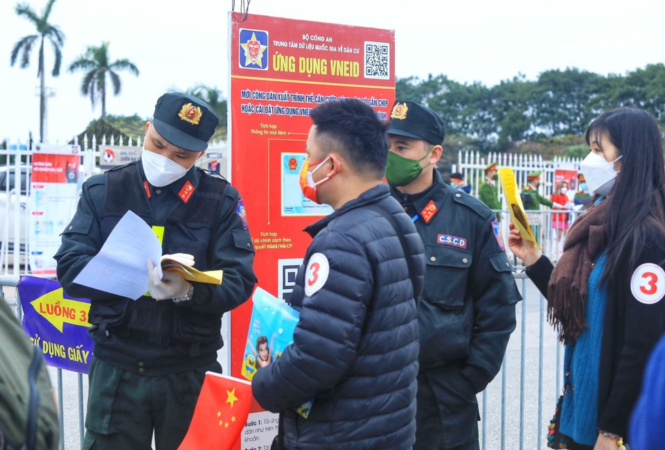 Lực lượng chức năng kiểm tra vé và các giấy xác nhận đã test COVID-19 đối với khán giả vào sân. (Ảnh: Tuấn Anh/TTXVN)