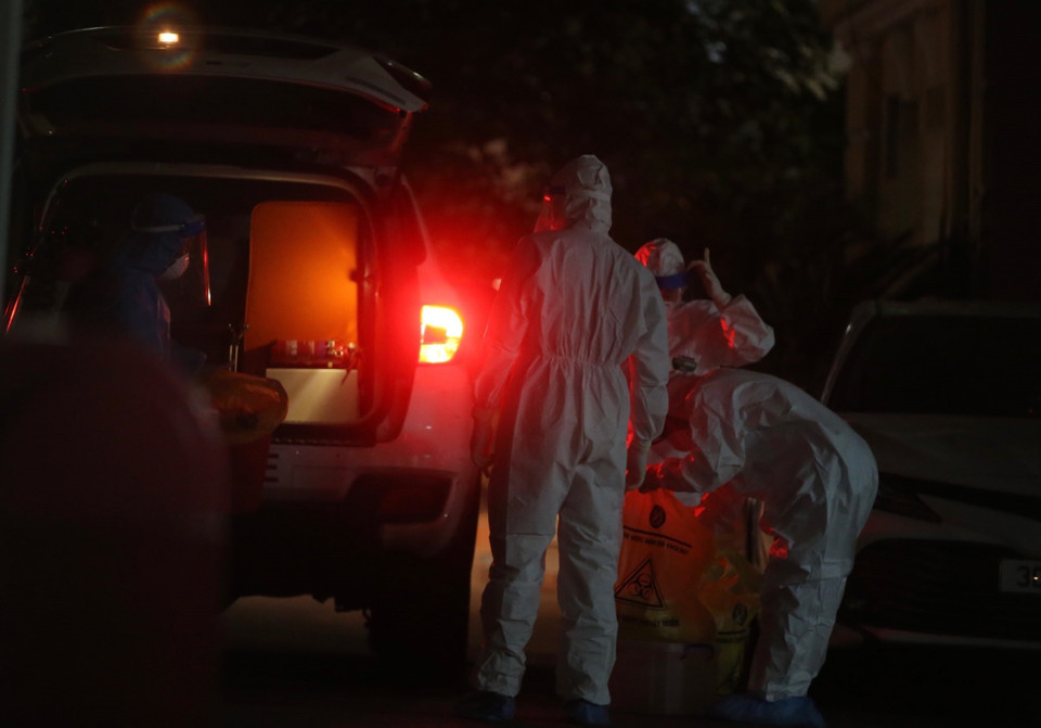 Nhân viên y tế chuyển đồ chuẩn bị làm xét nghiệm. (Ảnh: Hoàng Hiếu/TTXVN)