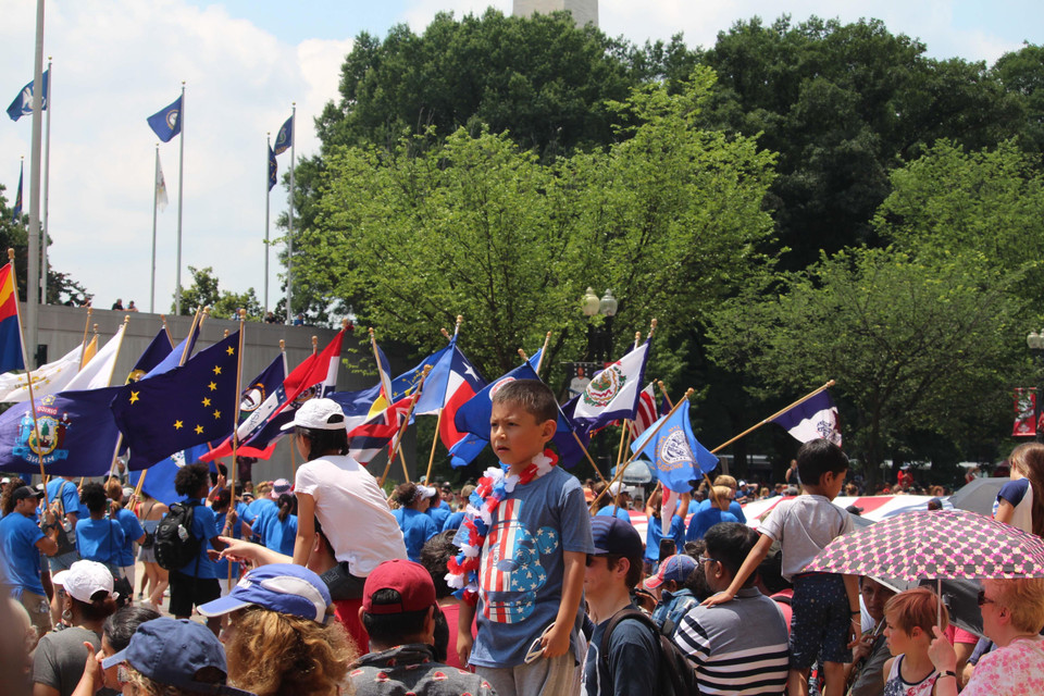 Một em bé đáng yêu đang chờ đoàn diễu hành đi tới. (Ảnh: Đặng Huyền/TTXVN)