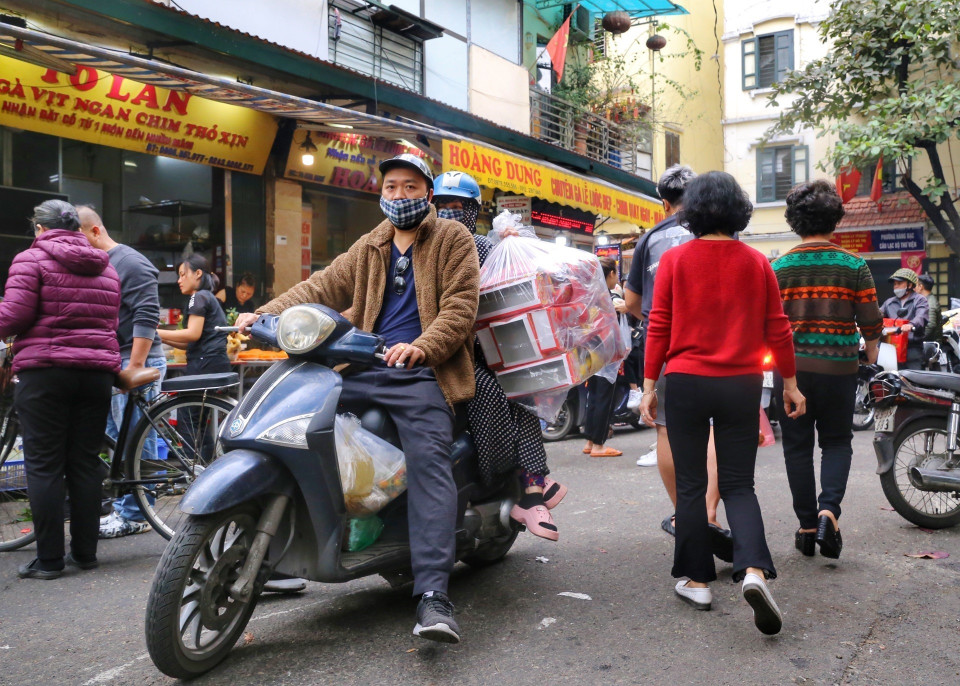 Người dân Thủ đô mua sắm đồ cúng ông Công, ông Táo. (Ảnh: Tuấn Đức/TTXVN)