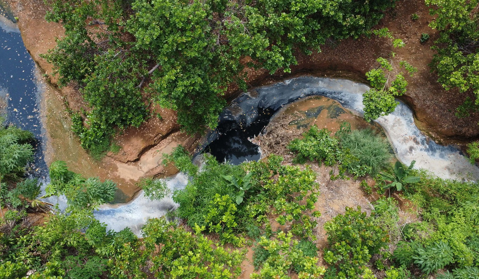Nước Suối Tân chuyển thành màu đen đặc quánh, bốc mùi hôi nồng nặc kéo dài hàng chục cây số. (Ảnh: Đậu Tất Thành/TTXVN)