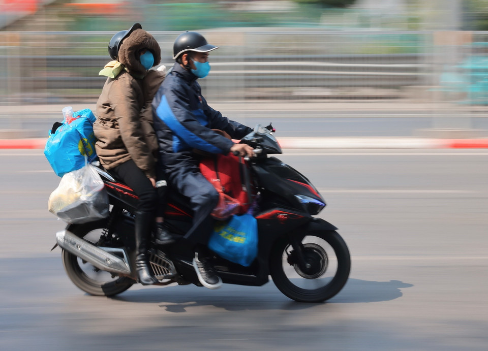 Người dân với hành lý được chằng buộc cẩn thận di chuyển từ phía Nam về hướng trung tâm thành phố. (Ảnh: Hoàng Hiếu/TTXVN)