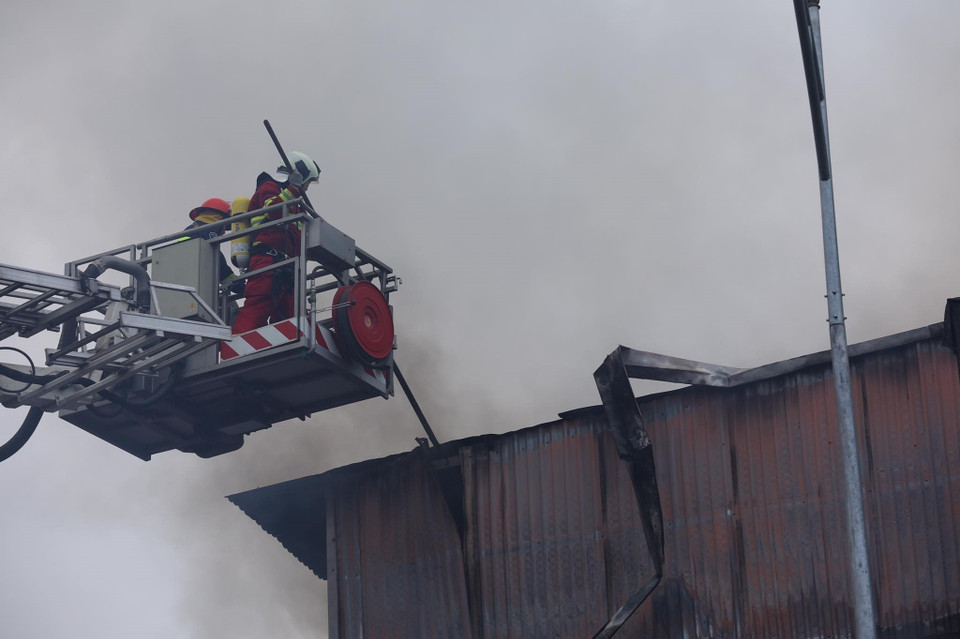 Lực lượng chức năng sử dụng xe thang tiếp cận đám cháy. (Ảnh: Hoàng Hiếu/TTXVN)