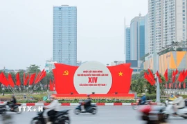 Khẩu hiệu, biểu trưng Đại hội nổi bật giữa dòng xe qua lại trên đường phố Hà Nội. (Ảnh: Lê Đông/TTXVN)