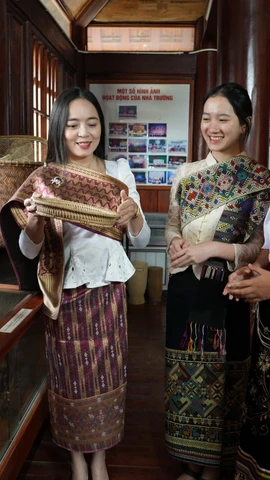 Em Bounsana Thidasavanh và các bạn tìm hiểu văn hóa truyền thống của Việt-Lào. (Ảnh: Bích Huệ/TTXVN)