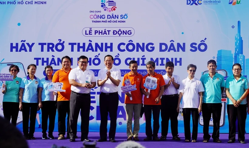 Chủ tịch Ủy ban Nhân dân Thành phố Hồ Chí Minh Phan Văn Mãi trao biểu trưng App Công dân số cho đại diện Ủy ban Mặt trận Tổ quốc Việt Nam thành phố. (Ảnh: Thu Hương/TTXVN)