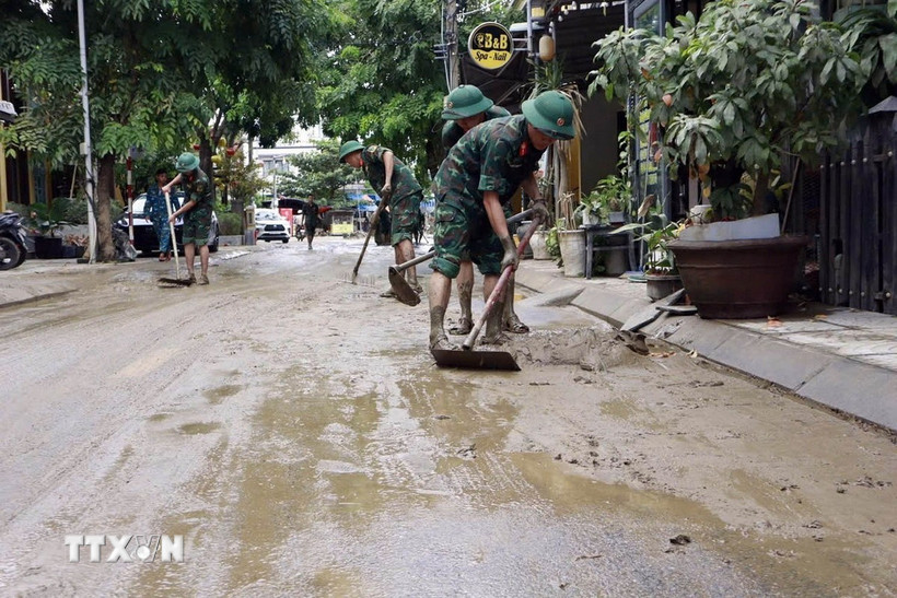 Bộ đội giúp nhân dân làm sạch, thu gom rác thải, tẩy rửa môi trường. (Ảnh: Trần Tĩnh/TTXVN)