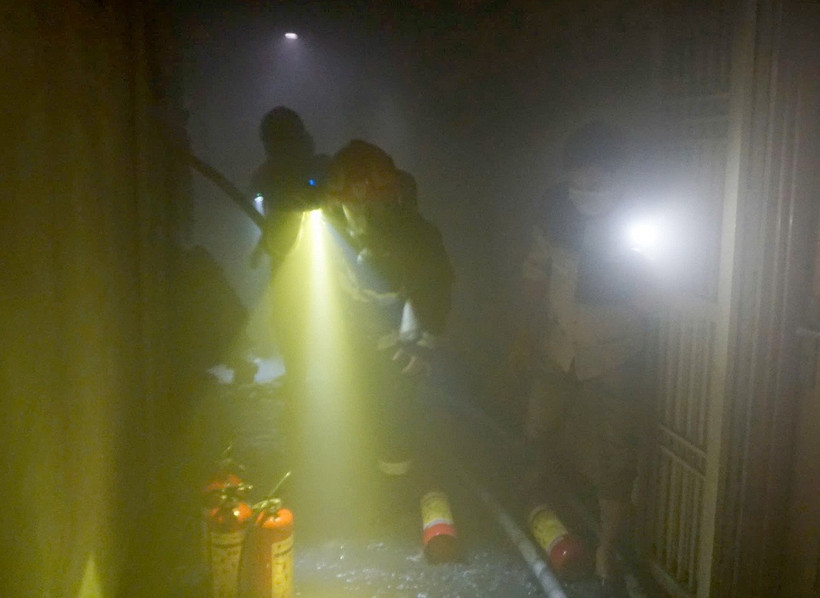 Lực lượng Cảnh sát Phòng cháy chữa cháy và Cứu nạn, cứu hộ tiếp cận căn hộ bị cháy để dập lửa. (Ảnh: TTXVN phát)