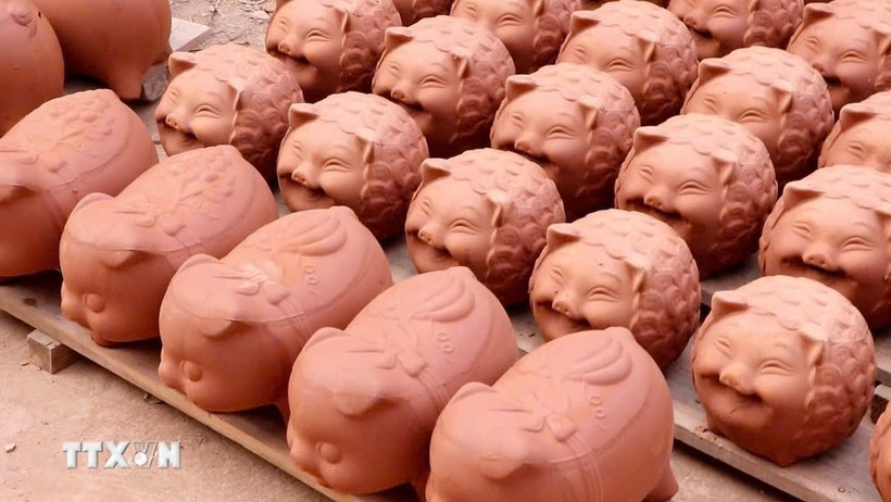 Những chú heo đất dễ thương được phơi khô dưới nắng, chờ vào lò nung. (Ảnh: Huyền Trang/TTXVN)