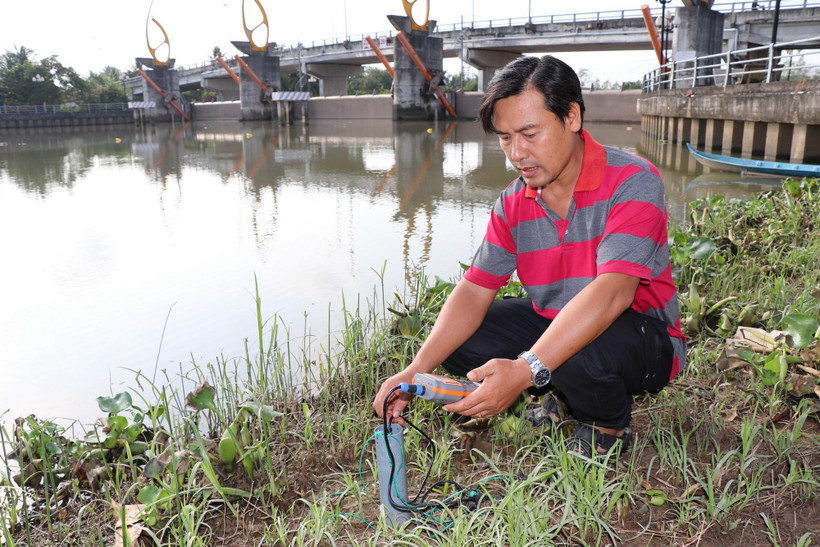 Xâm nhập mặn có xu hướng gia tăng tại Đồng bằng sông Cửu Long Đo độ mặn bên trong cống Bông Bót (xã An Phú Tân, Vĩnh Long) để đóng, mở cống phù hợp. (Ảnh: Thanh Hòa/TTXVN)