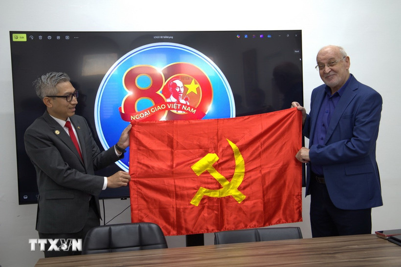 Đại sứ Việt Nam tại Israel Lý Đức Trung tặng cờ Đảng cho đồng chí Issam Makhoul, Ủy viên Bộ Chính trị Đảng Cộng sản Israel, Chủ tịch Hadash. (Ảnh: Thanh Bình/TTXVN)
