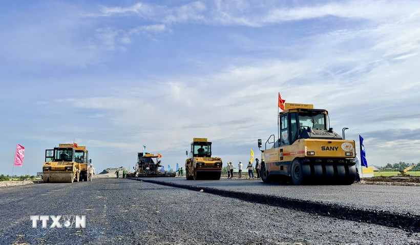 Thi công thảm bê tông nhựa trên tuyến chính cao tốc đoạn qua địa bàn phường Vĩnh Tế, tỉnh An Giang. (Ảnh: Thanh Sang/TTXVN)