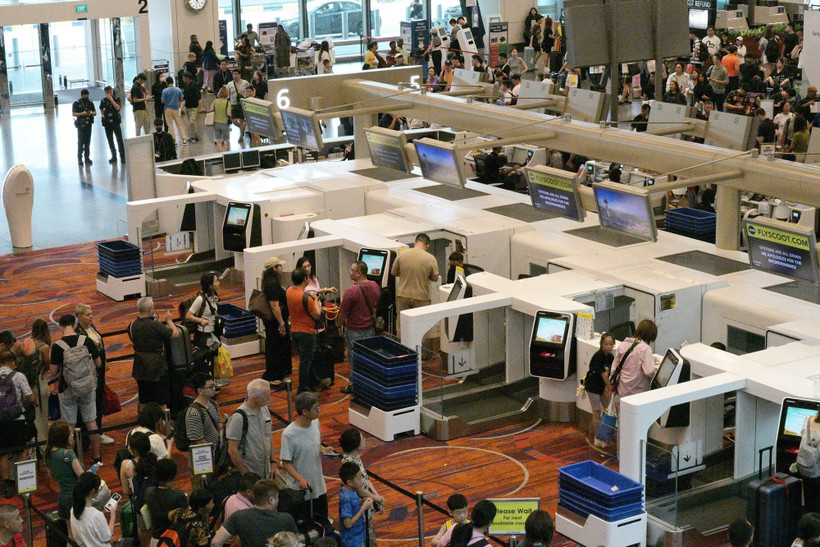 Hành khách xếp hàng tại quầy làm thủ tục ở sân bay Changi, Singapore. (Ảnh: THX/TTXVN)