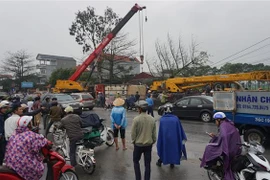 Xe gây tai nạn được cẩu đi để giải quyết ùn tắc. (Ảnh: Khiếu Tư/TTXVN)