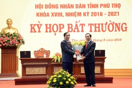 Bí thư Tỉnh ủy, Chủ tịch HĐND tỉnh Phú Thọ Bùi Minh Châu tặng hoa chia tay ông Vi Trọng Lễ, nguyên Phó Chủ tịch HĐND tỉnh. (Ảnh: Trung Kiên/TTXVN)