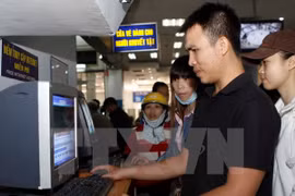 Hành khách mua vé tàu Tết Ất Mùi 2015 qua hệ thống bán vé điện tử tại Sài Gòn. (Ảnh: Hoàng Hải/TTXVN)
