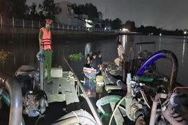 Lực lượng công an kiểm tra phát hiện ghe có gắn máy chạy, máy hút và một số thiết bị đặc thù sử dụng để bơm hút cát. (Ảnh: TTXVN phát)