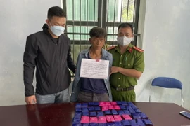 Đối tượng Lò Văn Lún cùng tang vật bị thu giữ tại Cơ quan Công an. (Ảnh: TTXVN phát)