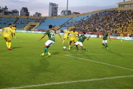 Tình huống bóng trên sân Thiên Trường giữa câu lạc bộ Nam Định và TP Hồ Chí Minh. (Ảnh: Công Luật/TTXVN)