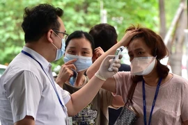 Kiểm tra thân nhiệt cho người dân Hàn Quốc để phòng tránh lây nhiễm MERS tại Trung tâm Y tế Samsung ở thủ đô Seoul ngày 20/7. (Nguồn: AFP/TTXVN)