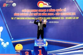 Trần Quyết Chiến lên bục nhận Cup nhà vô địch Giải Billiards Carom 3 băng Quốc tế Bình Dương lần thứ 12 năm 2024. (Ảnh: TTXVN phát)