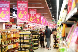 Người tiêu dùng mua sắm tại siêu thị ở tỉnh Giang Tô, Trung Quốc. (Ảnh: THX/TTXVN)