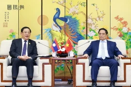 Thủ tướng Phạm Minh Chính tiếp Thủ tướng Lào Sonexay Siphandone. (Ảnh: Dương Giang/TTXVN)