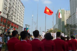 Quốc kỳ Việt Nam tung bay tại buổi lễ. (Nguồn: Vietnam+)