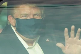 Tổng thống Mỹ Donald Trump vẫy chào những người ủng hộ bên ngoài Trung tâm Quân y quốc gia Walter Reed ở Bethesda, Maryland ngày 4/10. (Ảnh: AFP/TTXVN)