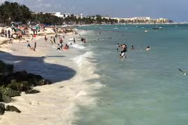 Khách du lịch tắm biển tại bang Quintana Roo, Mexico. (Nguồn: AFP/TTXVN)
