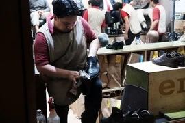 Nhân viên làm việc tại một cửa hàng giày ở trung tâm thương mại Rockefeller, thành phố New York, Mỹ. (Nguồn: AFP/TTXVN)