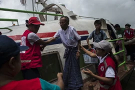 Nhân viện Hội Chữ thập Đỏ Malaysia hỗ trợ người dân sơ tán khỏi khu vực bạo lực ở bang Rakhine ngày 30/8. (Nguồn: AFP/TTXVN)
