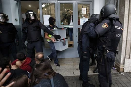 Cảnh sát Tây Ban nha tịch thu các hòm phiếu tại một điểm bỏ phiếu ở Barcelona ngày 1/10. (Nguồn: AFP/TTXVN)