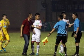 Ban huấn luyện và cầu thủ Sông Lam Nghệ An phản ứng trước quyết định đá phạt 11m của trọng tài trong trận gặp FLC Thanh Hóa. (Ảnh: Thanh Tùng/TTXVN)