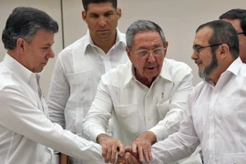 Thủ lĩnh FARC Timoleon Jimenez (phải) và Tổng thống Colombia Juan Manuel Santos (trái), Chủ tịch Cuba Raul Castro (giữa) tại lễ ký kết thỏa thuận hòa bình ở La Habana. (Nguồn: AFP/TTXVN)