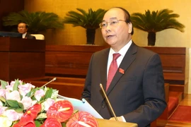 Thủ tướng Nguyễn Xuân Phúc trình bày báo cáo trước Quốc hội sáng 29/7. (Ảnh: Thống Nhất/TTXVN)
