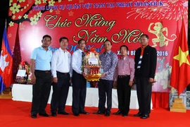 Đại tướng Teng Suon, Phó Tổng thư ký Ủy ban Quốc gia an ninh Biển Campuchia (thứ ba từ phải sang) tặng quà chúc Tết Tổng lãnh sự Đỗ Sỹ Kiều (thứ 3 từ trái sang). (Ảnh: Xuân Khu/Vietnam+)