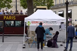 Nhân viên y tế lấy mẫu xét nghiệm COVID-19 cho người dân tại Paris, Pháp ngày 1/7/2022. (Ảnh: AFP/TTXVN)
