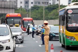 Lực lượng cảnh sát giao thông và thanh tra giao thông phân luồng phương tiện trên cao tốc Pháp Vân hướng đi vào Thủ đô Hà Nội. (Ảnh: TTXVN)