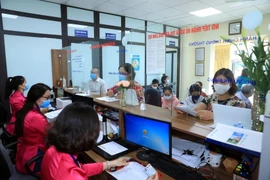 Người dân làm thủ tục hành chính tại Ủy ban Nhân dân phường. (Ảnh minh họa: Xuân Quảng/Vietnam+)