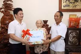 Phó Chủ tịch Thường trực UBND tỉnh Nam Định Trần Anh Dũng tặng quà cho Bà mẹ Việt Nam Anh hùng Trần Thị Chúc, sinh năm 1925, tại xã Mỹ Thắng. (Ảnh: Công Luật/TTXVN)