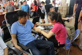 Người dân tham gia hiến máu tại Ngày hội hiến máu “Sắc đỏ dòng Thương." (Ảnh: PV/Vietnam+)