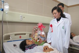 Bộ trưởng Bộ Y tế Nguyễn Thị Kim Tiến thăm hỏi bệnh nhân điều trị tại Trung tâm Ung bướu, Bệnh viện Bạch Mai. (Ảnh: PV/Vietnam+)
