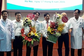 Giáo sư Trần Bình Giang (thứ ba từ trái sang) và Thứ trưởng Nguyễn Viết Tiến (thứ tư từ trái sang) tại buổi lễ bàn giao. (Ảnh: Thùy Giang/Vietnam+)