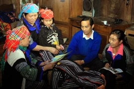 Cán bộ dân số tuyên truyền về sức khỏe sinh sản cho người dân vùng cao. (Ảnh: Dương Ngọc/TTXVN)